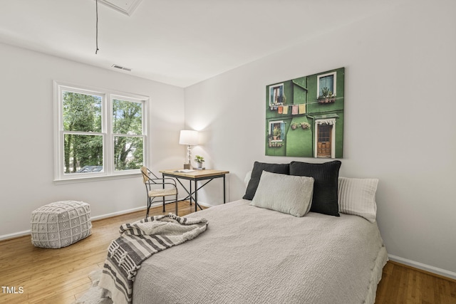 1605 Valley Run, Durham, NC 27707 - bedroom with wood finished floors, baseboards, and attic access
