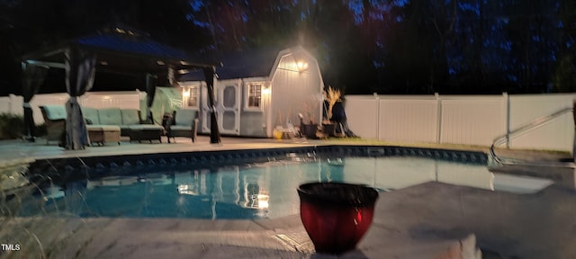 pool at twilight featuring a patio, a fenced in pool, a gazebo, fence, and an outdoor living space