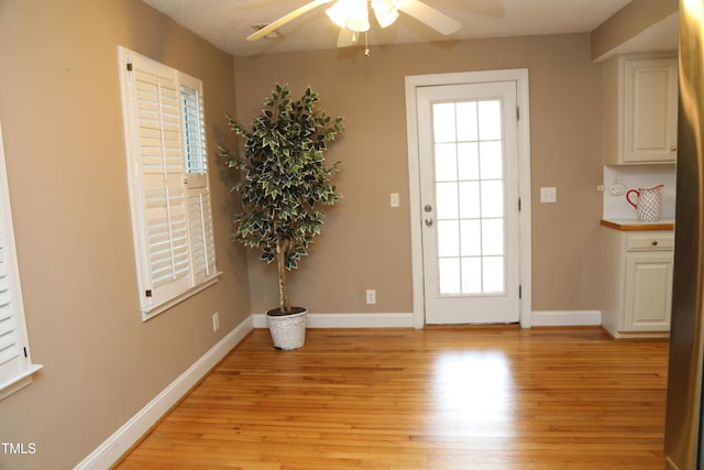 1927 Simpkins Rd, Raleigh, NC 27603 - doorway with light wood finished floors, a ceiling fan, and healthy amount of natural light