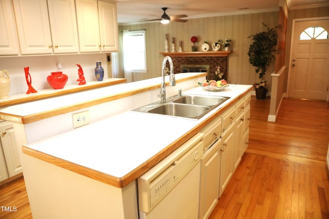 1927 Simpkins Rd, Raleigh, NC 27603 - kitchen with white dishwasher, a ceiling fan, light wood-style flooring, light countertops, and crown molding