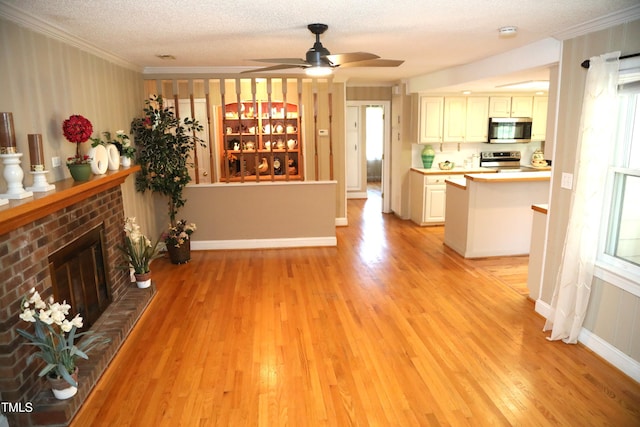 1927 Simpkins Rd, Raleigh, NC 27603 - living area with crown molding, light wood finished floors, a fireplace, a textured ceiling, and a ceiling fan