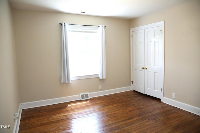 1927 Simpkins Rd, Raleigh, NC 27603 - unfurnished bedroom featuring dark wood-type flooring and a closet