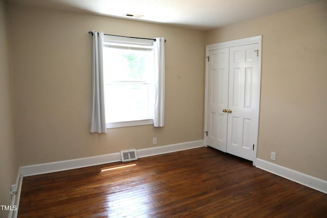 1927 Simpkins Rd, Raleigh, NC 27603 - unfurnished bedroom featuring dark wood-style floors and a closet