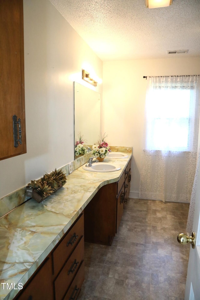 1927 Simpkins Rd, Raleigh, NC 27603 - full bath featuring double vanity and a textured ceiling