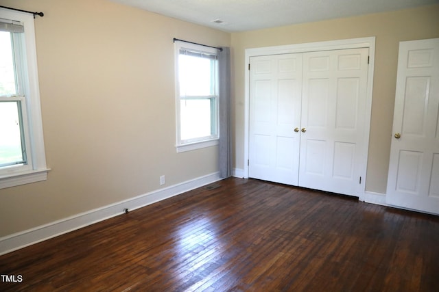 1927 Simpkins Rd, Raleigh, NC 27603 - unfurnished bedroom with dark wood-type flooring and a closet