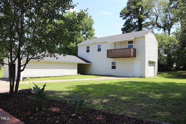1927 Simpkins Rd, Raleigh, NC 27603 - rear view of property with an attached garage, a balcony, and a yard