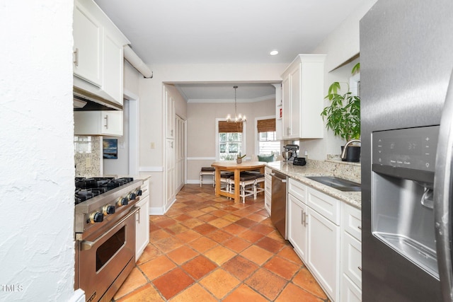 kitchen with crown molding, under cabinet range hood, a chandelier, a sink, and appliances with stainless steel finishes