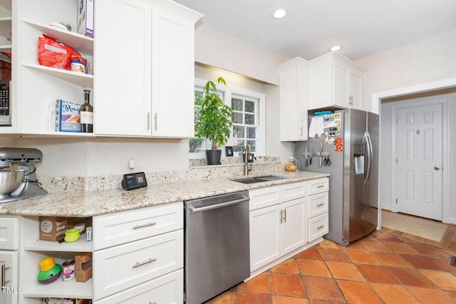 kitchen with open shelves, a sink, white cabinetry, and stainless steel appliances