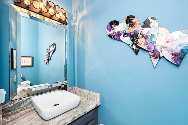 half bathroom with toilet and vanity