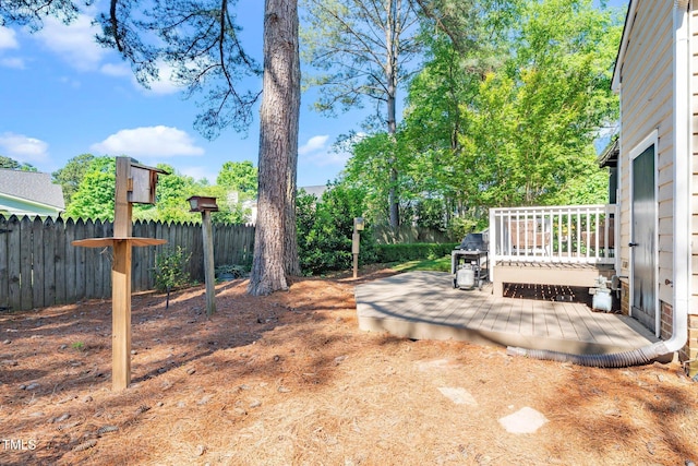 view of yard with fence and a deck