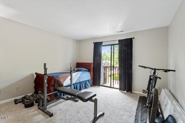 carpeted bedroom featuring access to outside, baseboards, and visible vents