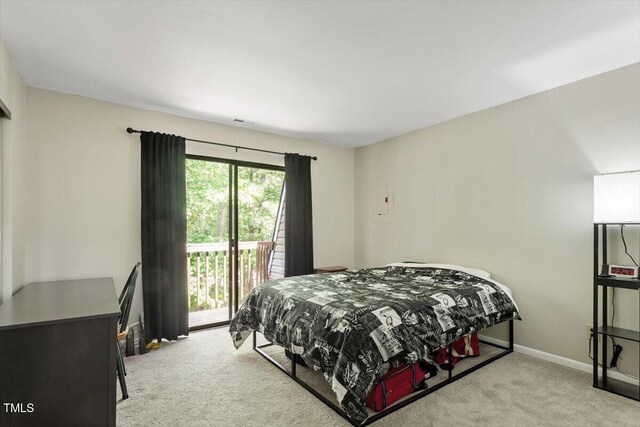 carpeted bedroom with baseboards, visible vents, and access to exterior