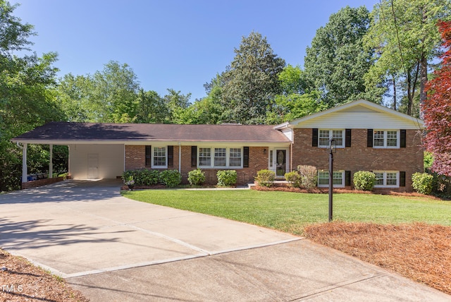 tri-level home featuring brick siding, an attached carport, driveway, and a front yard