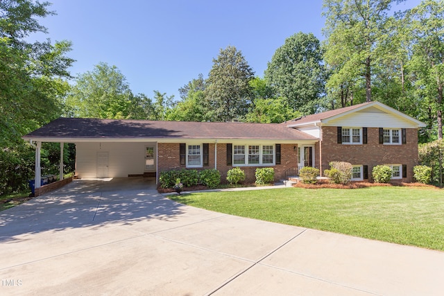 tri-level home with a carport, concrete driveway, a front lawn, and brick siding