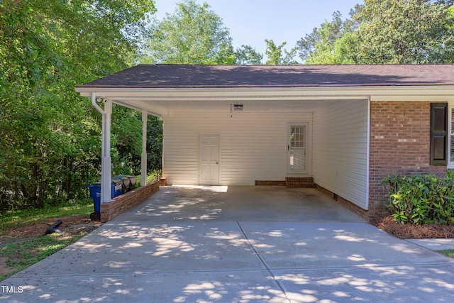 exterior space featuring an attached carport and concrete driveway