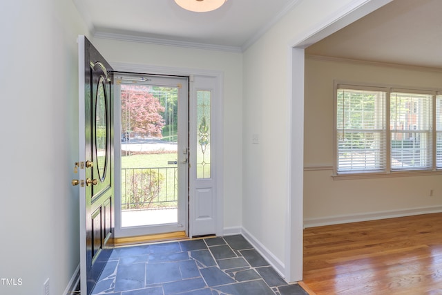 entryway with baseboards, plenty of natural light, and ornamental molding