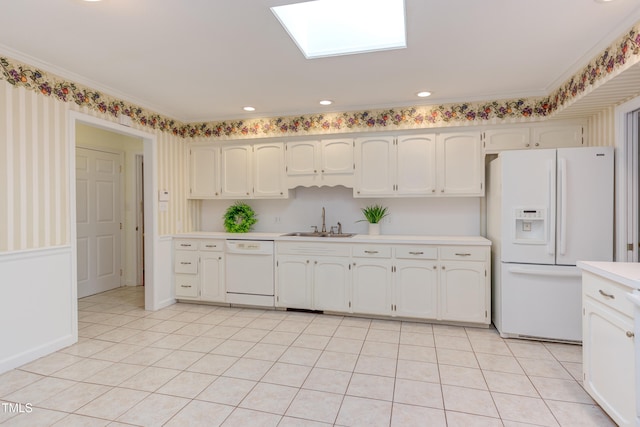 kitchen with light tile patterned flooring, white appliances, light countertops, white cabinetry, and a sink