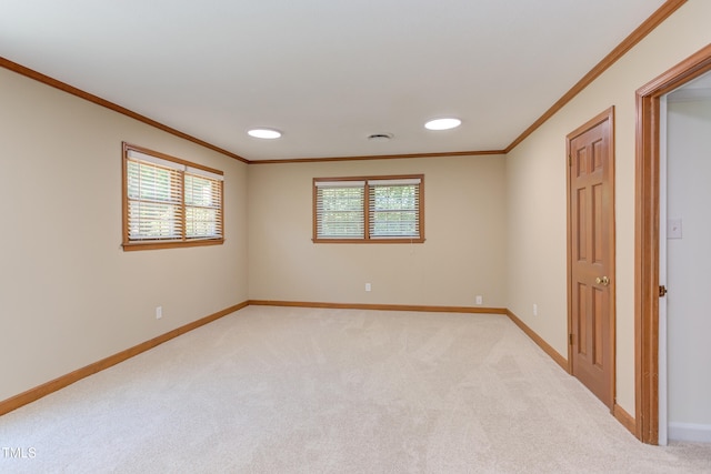 unfurnished room featuring baseboards, ornamental molding, and light colored carpet
