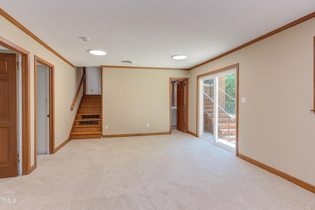 spare room with crown molding, baseboards, light colored carpet, and stairway