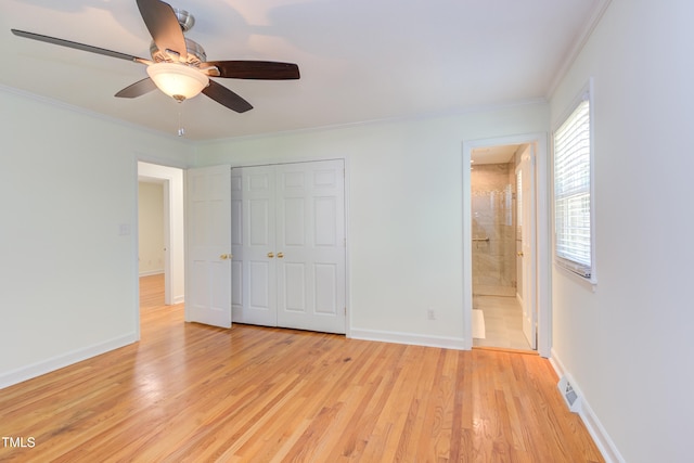 unfurnished bedroom with baseboards, ornamental molding, a closet, and light wood finished floors
