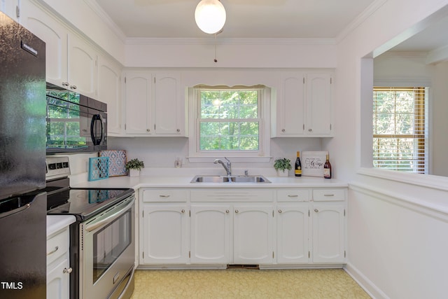 kitchen with white cabinetry, a wealth of natural light, a sink, and black appliances
