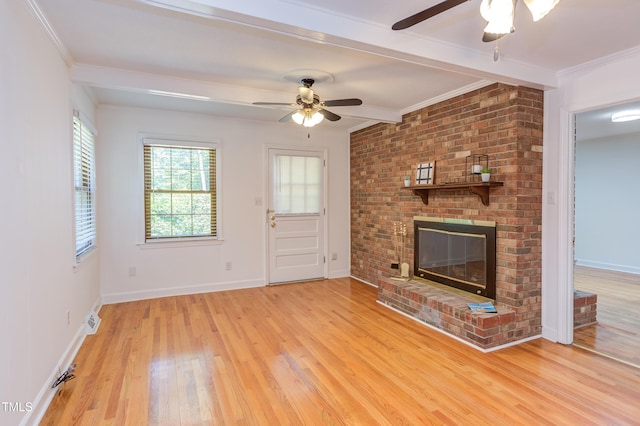unfurnished living room with ceiling fan, a fireplace, light wood-style floors, baseboards, and visible vents