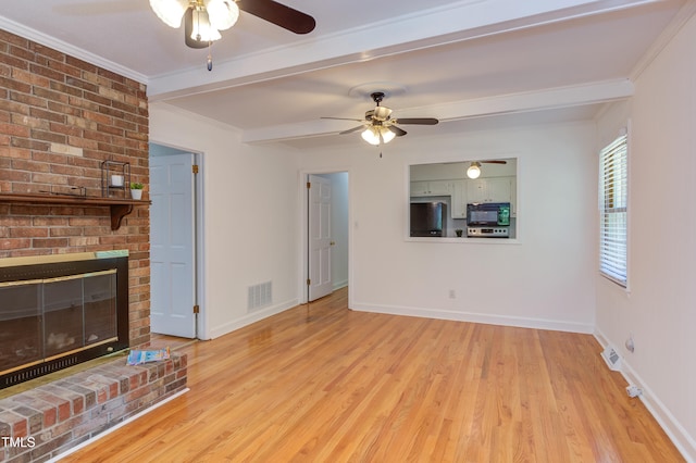 unfurnished living room with a ceiling fan, beamed ceiling, visible vents, and wood finished floors
