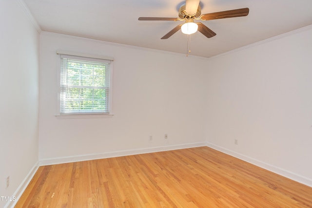 spare room featuring crown molding, baseboards, ceiling fan, and light wood-style flooring