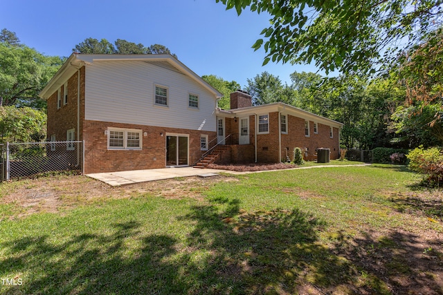 rear view of property featuring fence, brick siding, a chimney, cooling unit, and a patio area