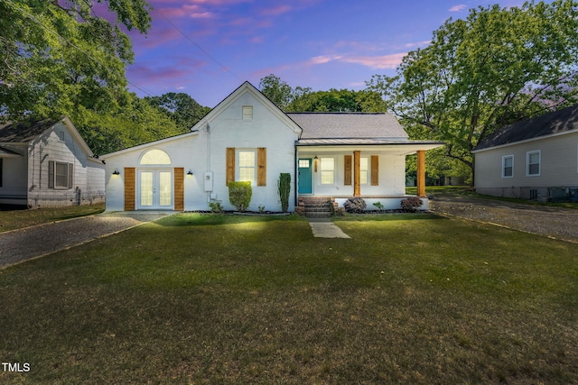 105 N 11th St, Erwin, NC 28339 - view of front of home featuring a porch, a standing seam roof, french doors, metal roof, and a front yard