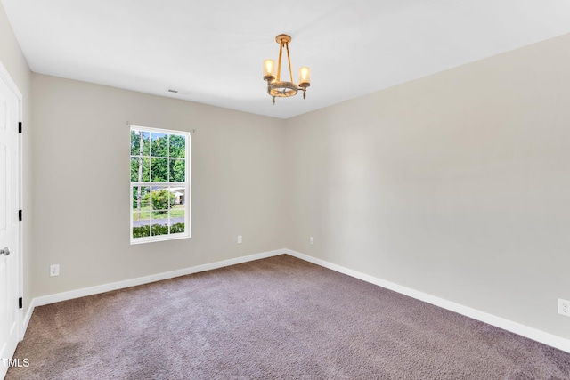 105 N 11th St, Erwin, NC 28339 - carpeted empty room featuring baseboards and a chandelier