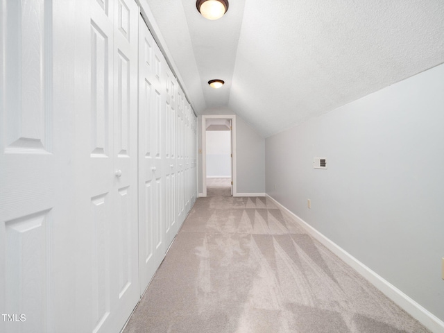 12823 Summerwind Trl, Rougemont, NC 27572 - corridor featuring light carpet, vaulted ceiling, baseboards, and a textured ceiling
