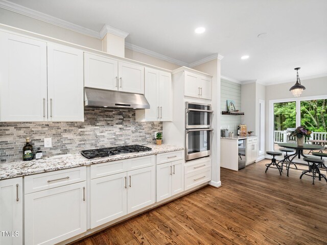 12823 Summerwind Trl, Rougemont, NC 27572 - kitchen with stainless steel appliances, under cabinet range hood, wood finished floors, white cabinetry, and decorative backsplash