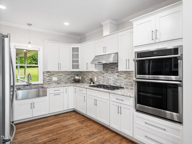 12823 Summerwind Trl, Rougemont, NC 27572 - kitchen featuring appliances with stainless steel finishes, under cabinet range hood, a sink, crown molding, and white cabinetry