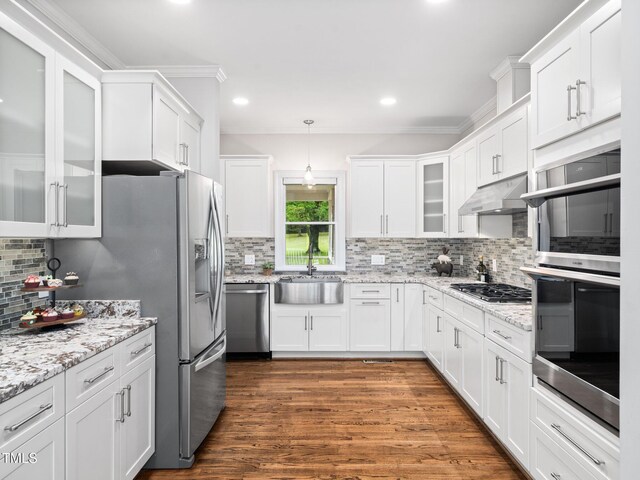 12823 Summerwind Trl, Rougemont, NC 27572 - kitchen featuring appliances with stainless steel finishes, a sink, under cabinet range hood, backsplash, and white cabinetry