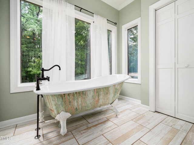 12823 Summerwind Trl, Rougemont, NC 27572 - full bath featuring healthy amount of natural light, a freestanding tub, crown molding, and baseboards
