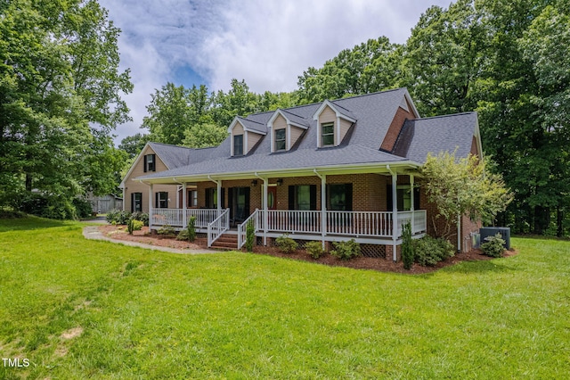 12823 Summerwind Trl, Rougemont, NC 27572 - new england style home with a porch, brick siding, a front lawn, view of wooded area, and a shingled roof