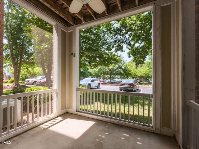 balcony with ceiling fan, covered porch, and cooling unit
