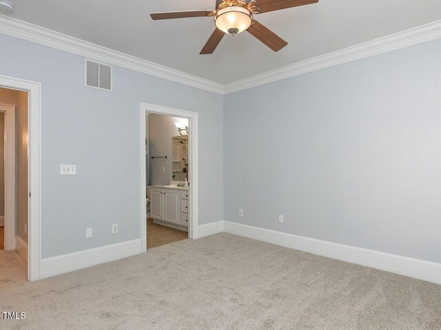 unfurnished bedroom with visible vents, baseboards, crown molding, and light carpet