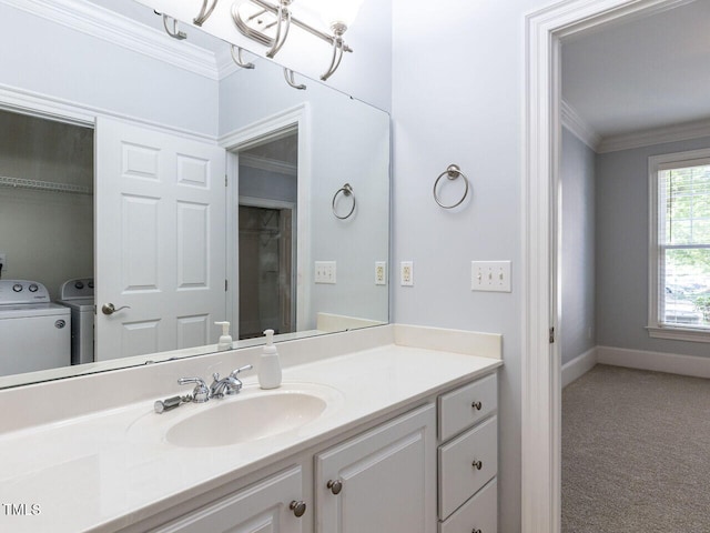 bathroom with separate washer and dryer, baseboards, ornamental molding, and vanity
