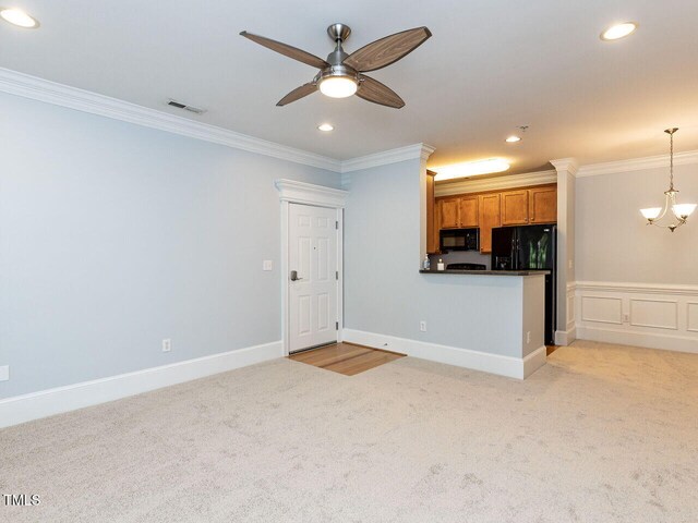 kitchen with crown molding, visible vents, light carpet, brown cabinets, and black appliances