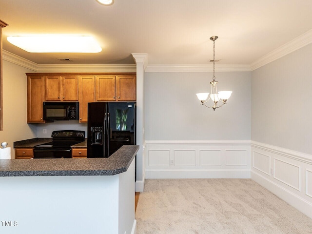 kitchen with crown molding, dark countertops, a chandelier, brown cabinets, and black appliances