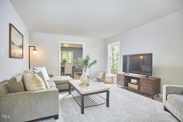 living area with carpet floors and a wealth of natural light