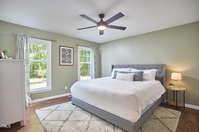 bedroom featuring baseboards, a ceiling fan, and wood finished floors