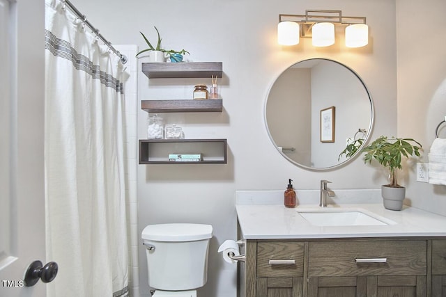 bathroom featuring toilet and vanity