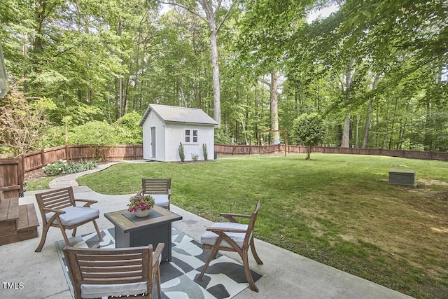view of patio featuring an outdoor structure and a fenced backyard
