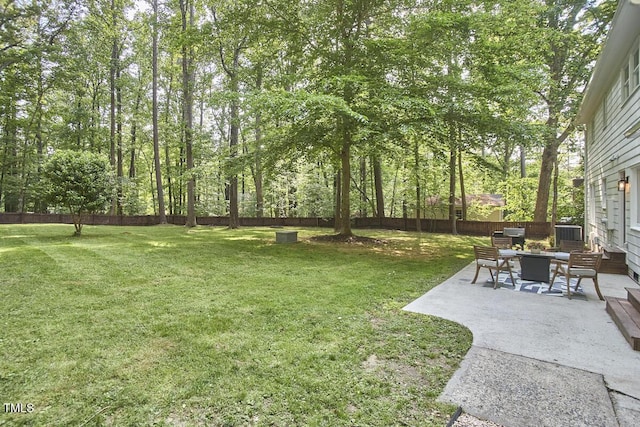 view of yard featuring a fenced backyard, a patio area, and central AC