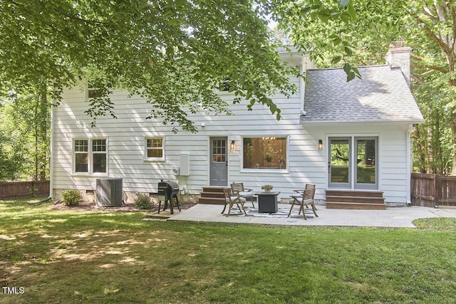 back of house with roof with shingles, fence, a yard, and entry steps