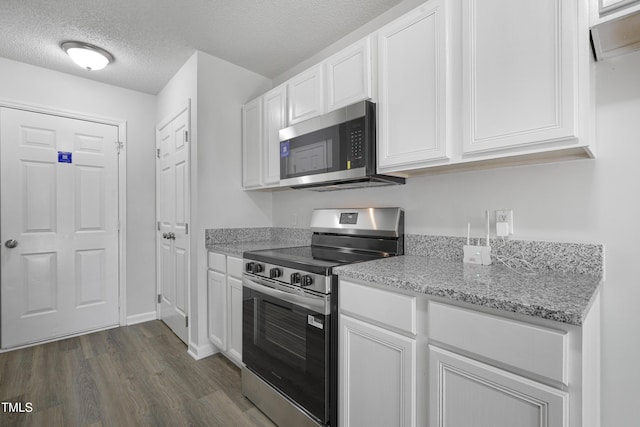 kitchen featuring white cabinets, dark wood-style flooring, light stone countertops, a textured ceiling, and stainless steel appliances