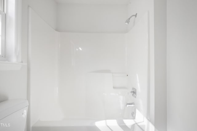 bathroom with shower / bath combination and toilet